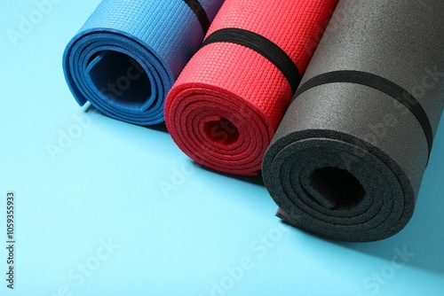 Different mats folded into a roll, karemat for camping, on color background  photo