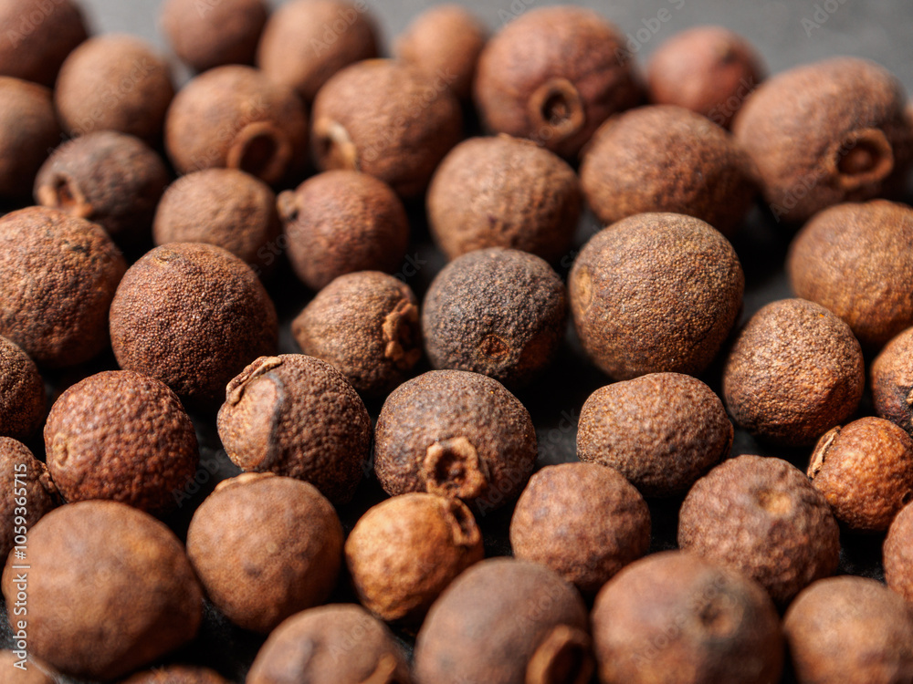 A close-up of black allspice, highlighting the texture and rich color A close-up of black allspice, highlighting the texture and rich color
