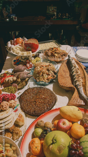 A festive table filled with a variety of local traditional Filipino dishes for the New year media noche meal celebration in the Philippines