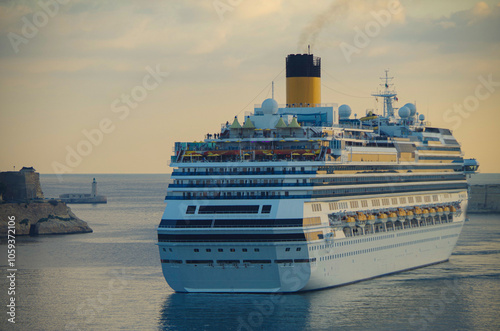 Modern Italian family cruiseship cruise ship liner Fascinosa morning arrival into port of Valletta, Malta with old town skyline and harbor entrance