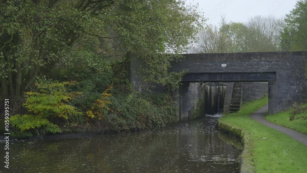 B-roll establishing shot of the Caldon Canal at bridge number 24 near Stockton Brook during the autumn season. B-roll establishing shot of the Caldon Canal at bridge number 24 near Stockton Brook during the autumn season.