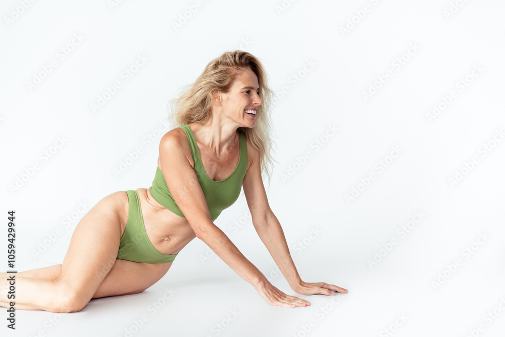 Photo of attractive mature blonde woman sit floor look empty space wear khaki fashion lingerie isolated white background no filter Photo of attractive mature blonde woman sit floor look empty space wear khaki fashion lingerie isolated white background no filter