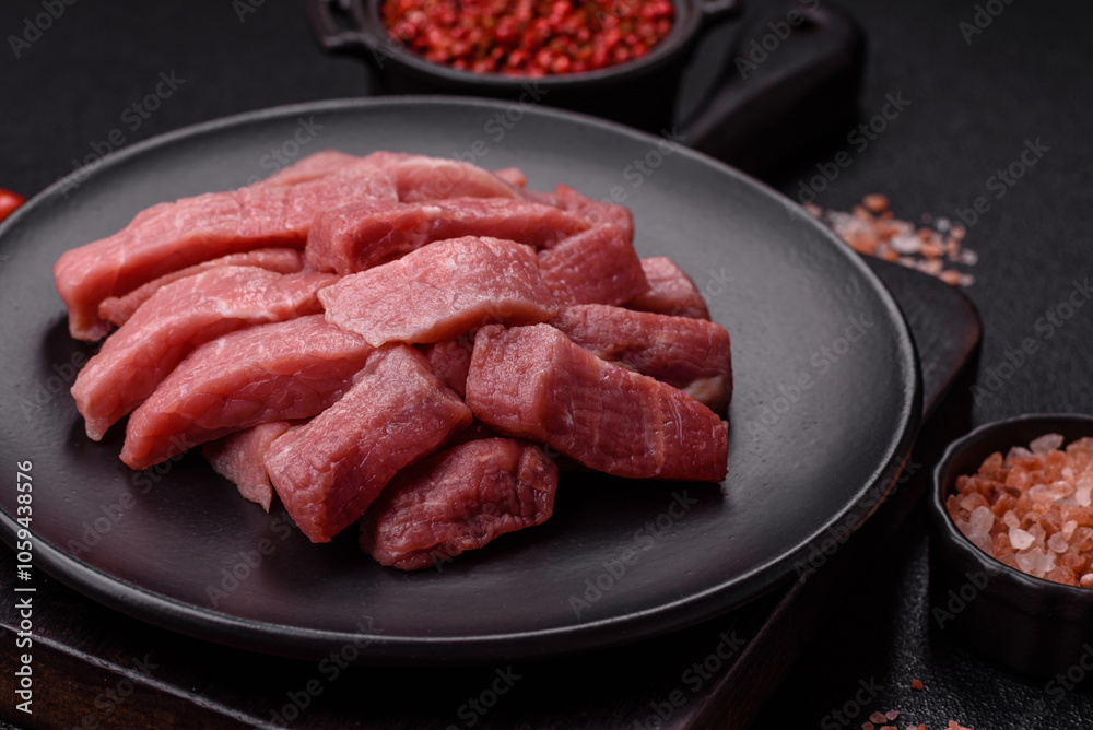 Juicy beef cut into slices with salt, spices and herbs Juicy beef cut into slices with salt, spices and herbs