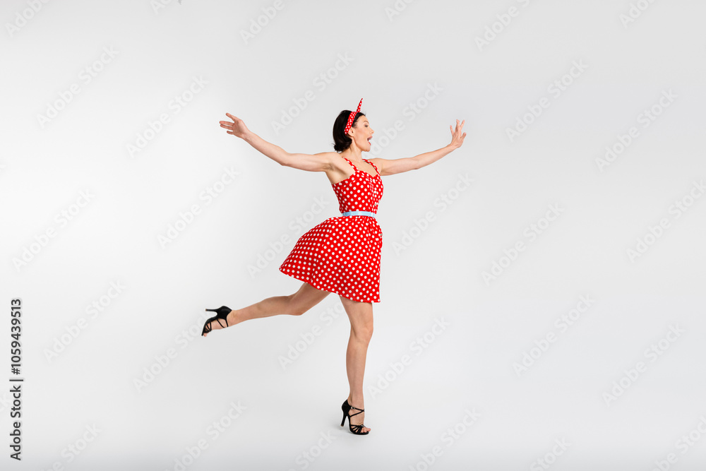 Fototapeta premium Full body photo of attractive woman dancing have fun enjoy holiday dressed red vintage style polka dot skirt isolated on white background