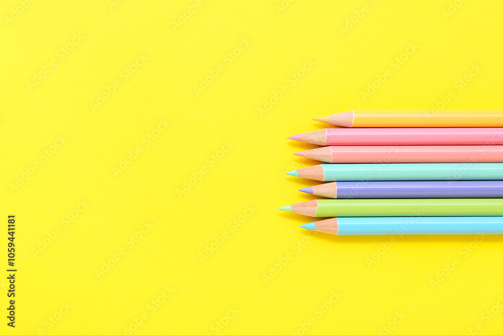 Set of colorful pencils on yellow background, closeup Set of colorful pencils on yellow background, closeup