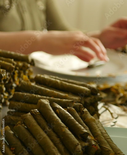 Obraz na płótnie A housewife wraps homemade vine-grape leaf stuffing, w salonie