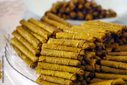 Obraz na płótnie Homemade stuffed vine leaves are arranged in a row on the table, w salonie