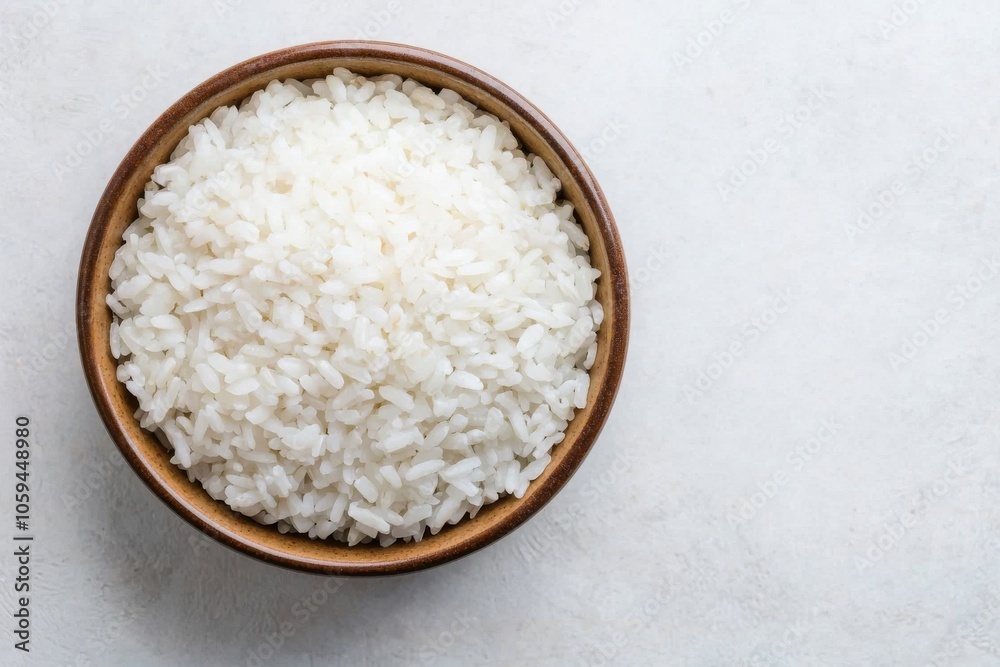 Bowl of white rice on a light textured background, perfect for culinary presentations. Bowl of white rice on a light textured background, perfect for culinary presentations.