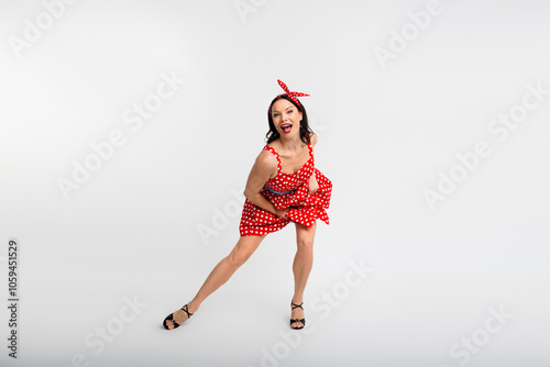 Full size photo of pretty girl energetic have fun enjoy dancing wear red retro style polka dot skirt isolated on white color background photo