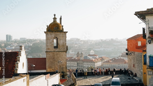 Group of tourists watches panoramic view of Porto city at sunset photo