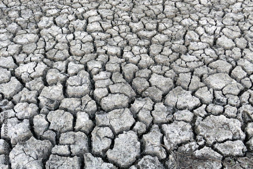 Obraz na płótnie Close-up: deep splitting and cracking of the soil as a result of the decrease in water,Close-up: deep splitting and cracking of the soil as a result of the decrease in water, w salonie