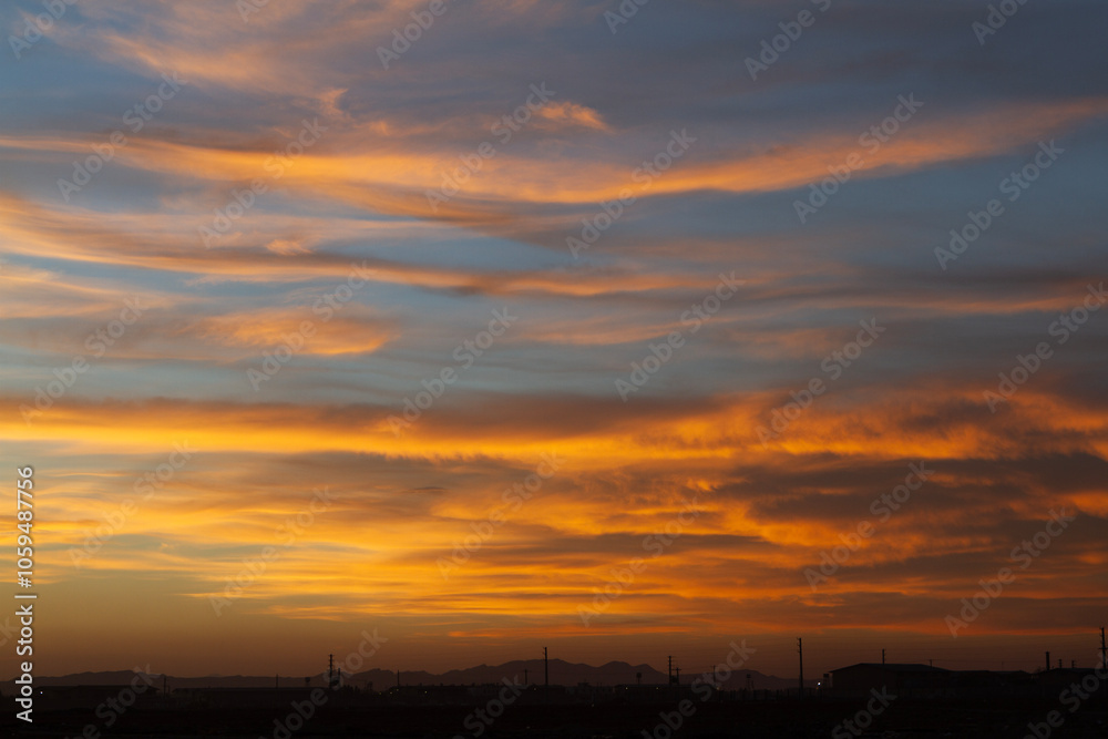 Beautiful , luxury soft gradient orange gold clouds and sunlight on the blue sky perfect for the background Beautiful , luxury soft gradient orange gold clouds and sunlight on the blue sky perfect for the background