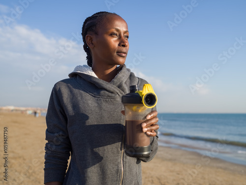 Woman holding protein drink photo