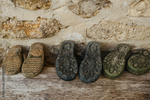 Antique shoe collection on weathered ledge photo