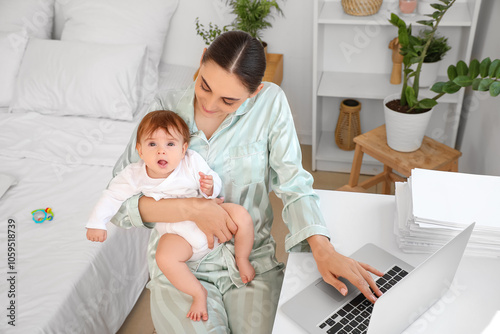 Young mother working remote...