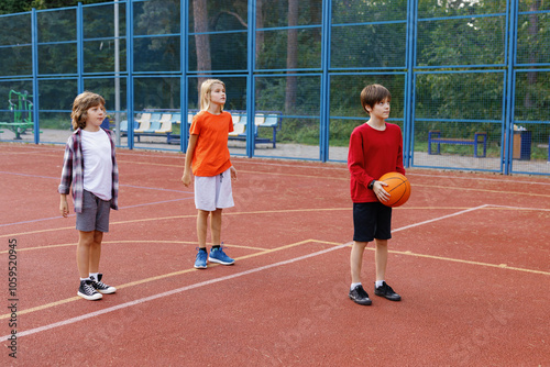 Boys lining up for free throws on outdoor basketball court