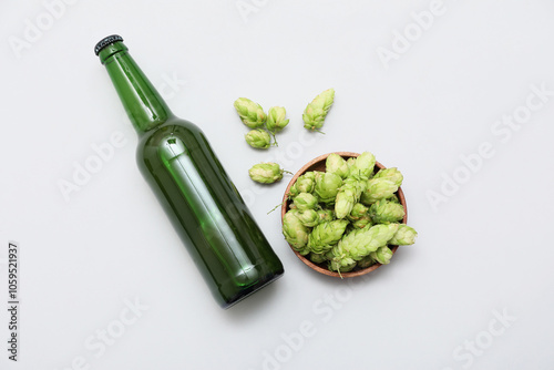 Canvas-taulu Bowl with green hops cones and bottle of beer on white background