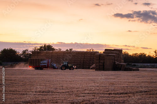 Hay baler against sunset photo