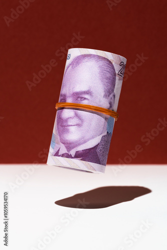 Turkish lira money roll hovering on red and white background photo