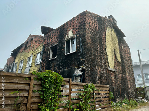 Burnt and heavily damaged building in Hostomel, Kyiv region, with exposed insulation and shattered windows, symbolizing the impact of the conflict on civilian infrastructure. photo