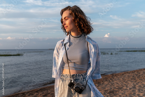  Woman Relaxing on a Beach with Camera photo