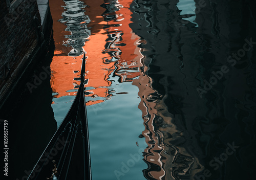 Venice, Italy:  gondola passing by the canal with reflection