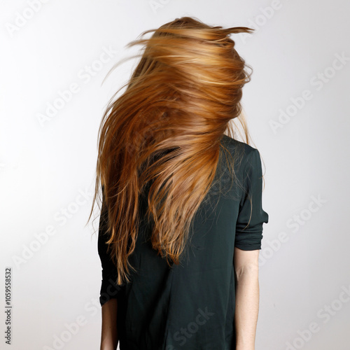 redhead waving her hair photo