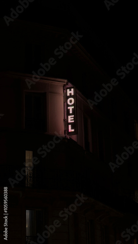 Illuminated hotel sign against a dark evening sky photo