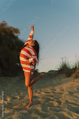 Girl in Striped Sweater Reaching Upward