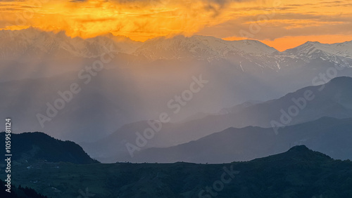 Sun Rays Over Mountain Range at Sunset
 photo