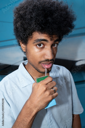 Young man drinking juice from a carton photo