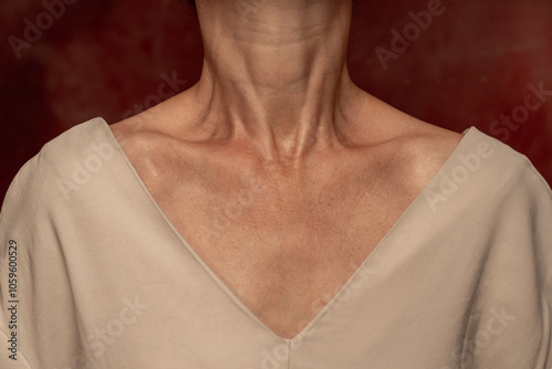 Close-up of Neck and Shoulders Against Red Background