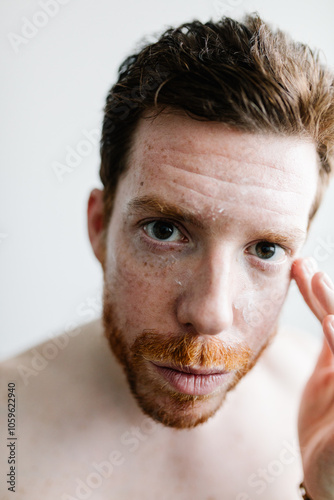 POV of a man staring at himself in the mirror while checking his skin photo