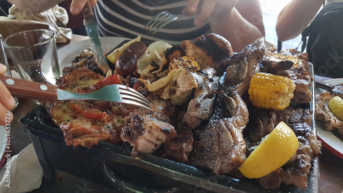 Argentina lifestyle: friends eating asado photo