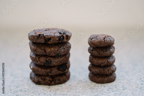 Stack of six chocolate cookies on a granite countertop. photo