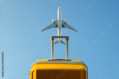 Yellow suitcase with luggage in the background of a passing aircraft  photo