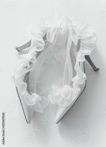 The stylish white high-heeled shoes feature a delicate frilly design, ideal for a bride's special day, highlighting fashionable bridal footwear.