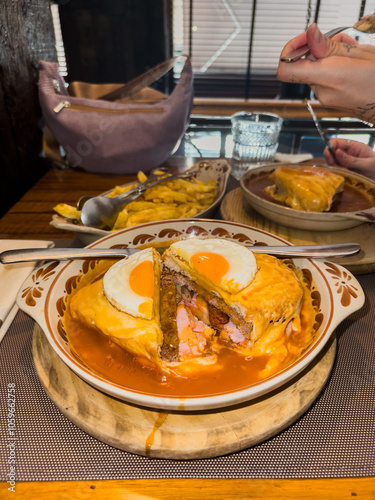 View of a Francesinha, a traditional portuguese dish, split in half photo