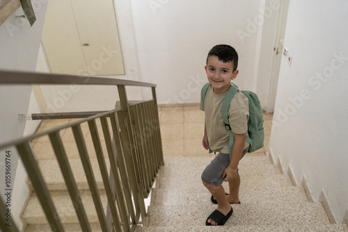 Boy Looking Back While Climbing Stairs To School photo