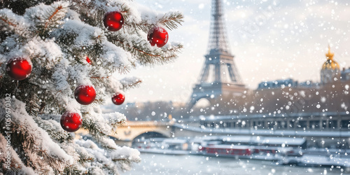 Christmas tree covered with snow and decorated with red baubles in Paris, France.