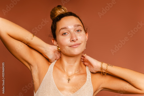 Woman With Radiant Skin And Shiny Gold Jewelry