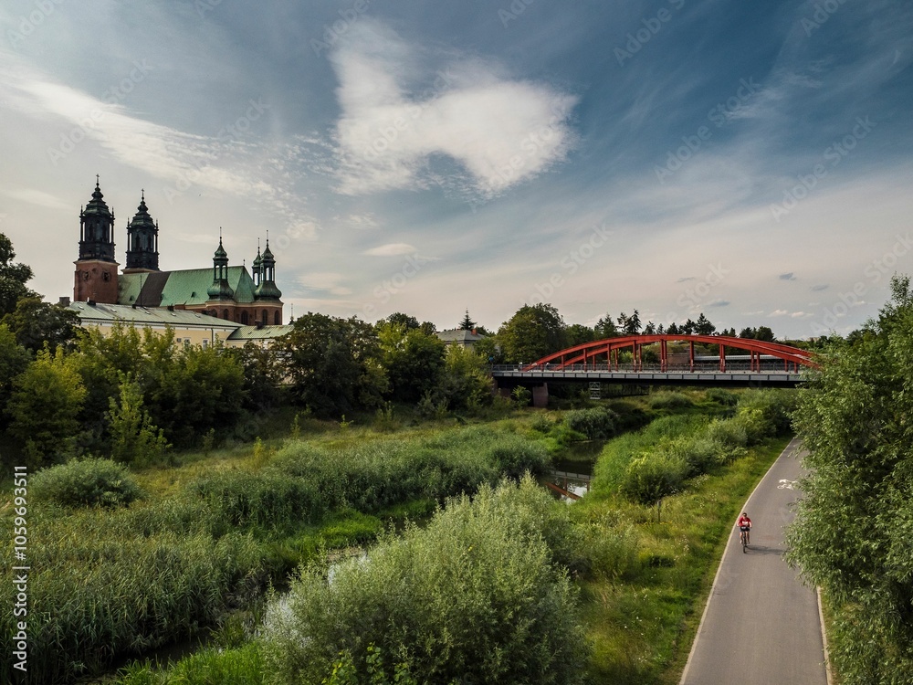 Naklejka premium Poznan Cathedral and cyclist near Cybina River