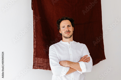 Man in white shirt against dark textured fabric