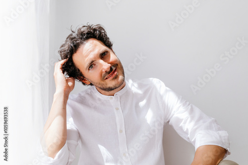 Man sitting on floor, soft natural light photo