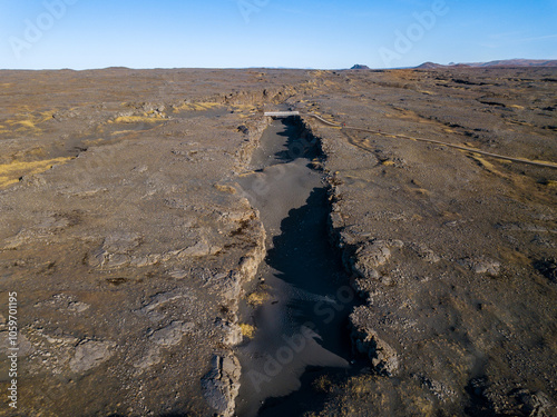 Aerial of the bridge connecting the north american and eurasian tectonic plates at Reykjanes, showcasing the dramatic rift between two major geological boundaries photo