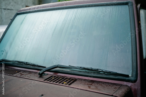 close-up view of sweaty car with dew all over windshield