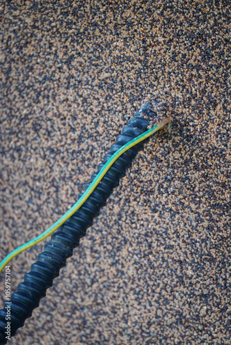 Outlet of protective shield and grounding cable from the wall.
 photo