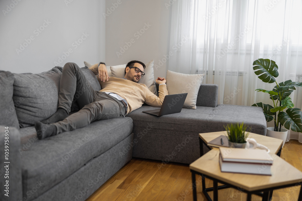 Man Relaxing Casually On Couch With Laptop At Home Man Relaxing Casually On Couch With Laptop At Home
