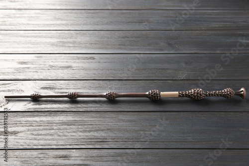 One old magic wand on wooden table photo