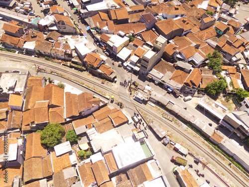 Bird eye view of Rail Train crossing from aerial perspective. Aerial shot of Rail track in the middle of the city. Transportation Industry. Mode of Transport. Cicalengka - Indonesia photo